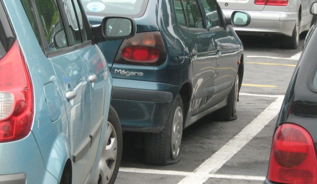 2 deflated tyres on a renault megane in a car park in abbeville